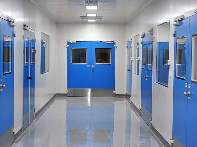 Pharmaceutical cleanroom corridor with epoxy flooring and blue doors